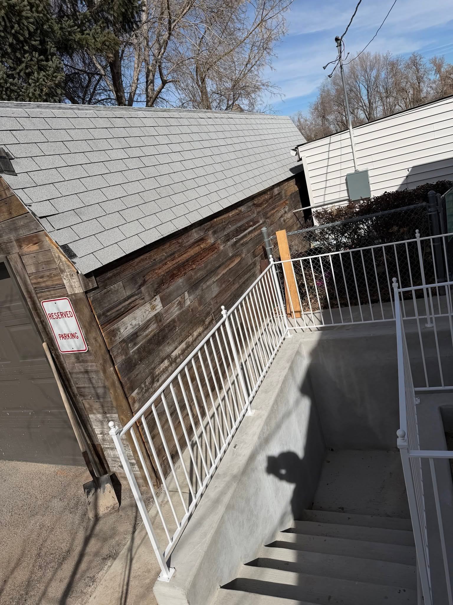 White stair railing down to a basement entry