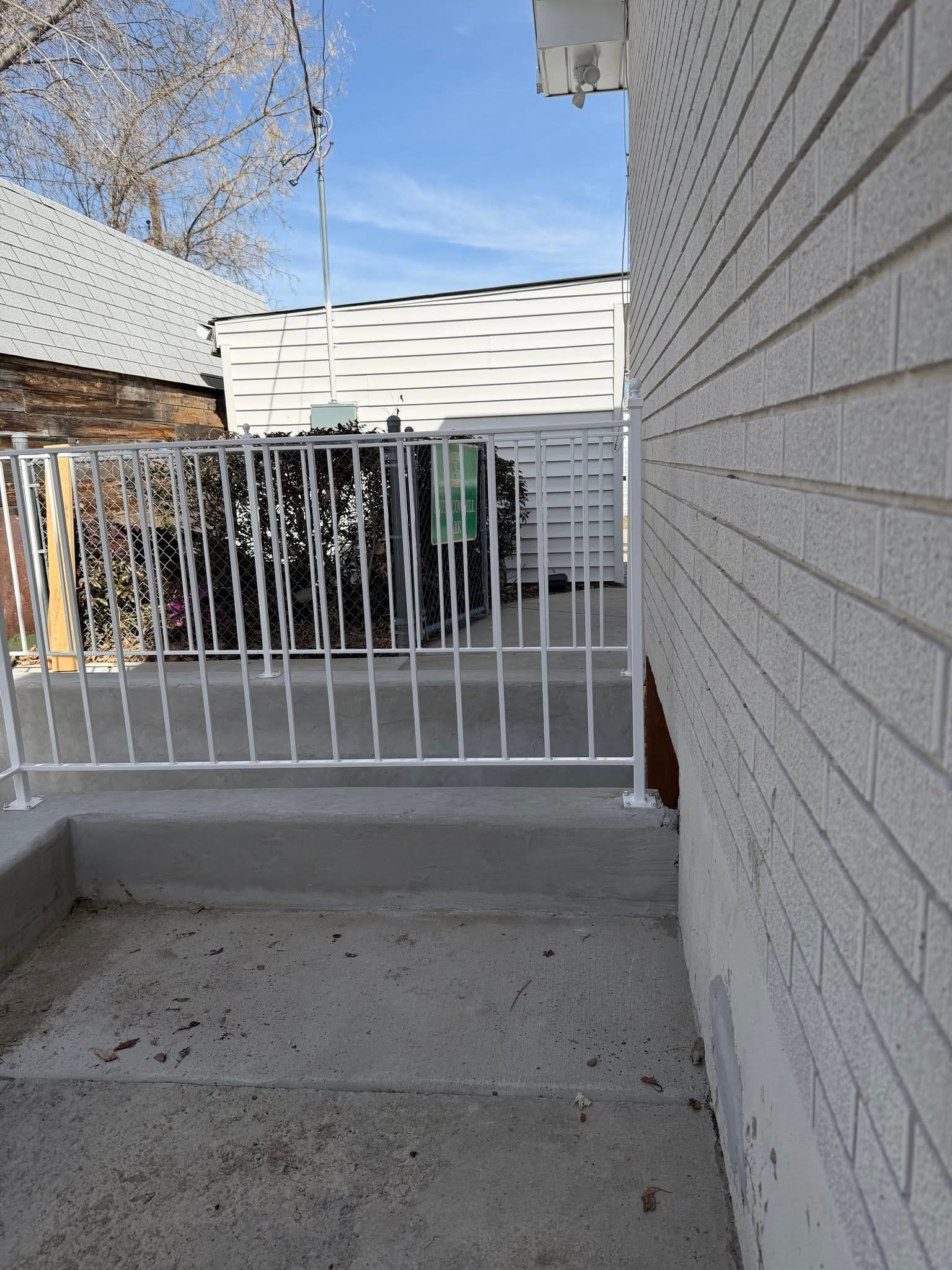 White guard railing around a stairwell and window well